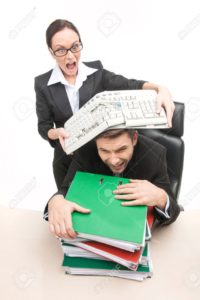 A woman in business suite and glasses breaking keyboard over a mans head as he clutches a pile of red and green reports